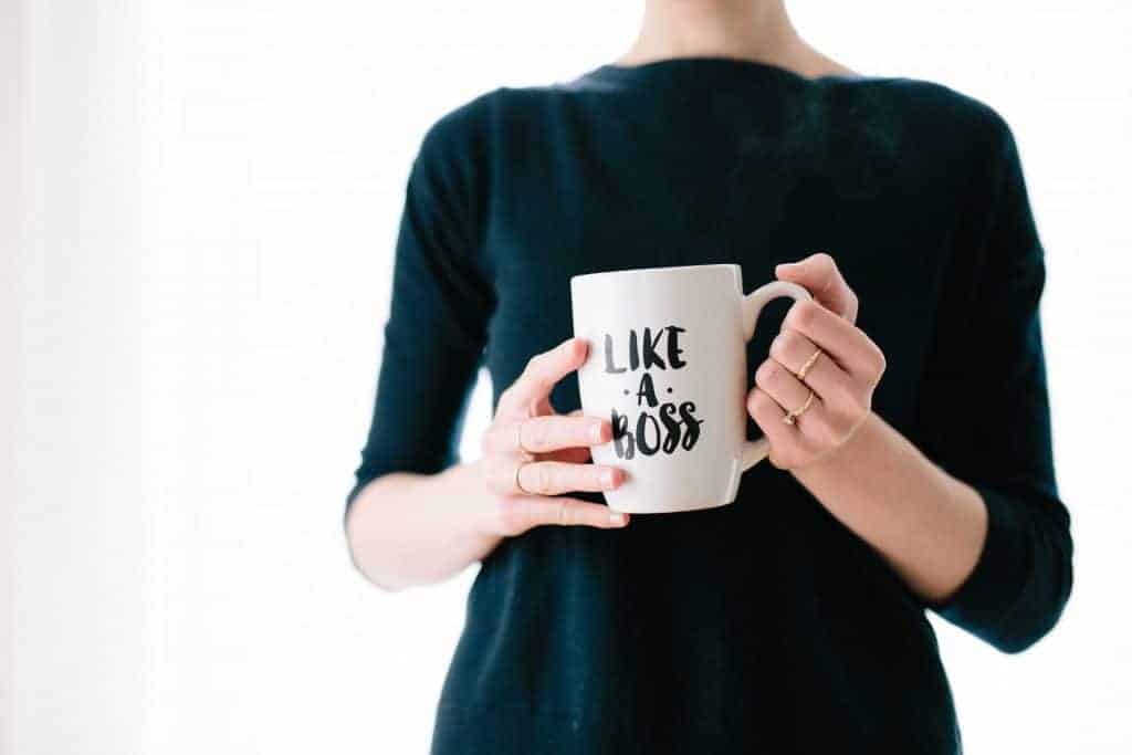 woman holding a like a boss coffee cup