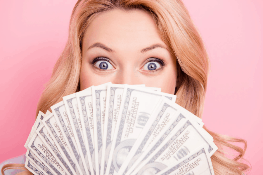 woman holding money over her face