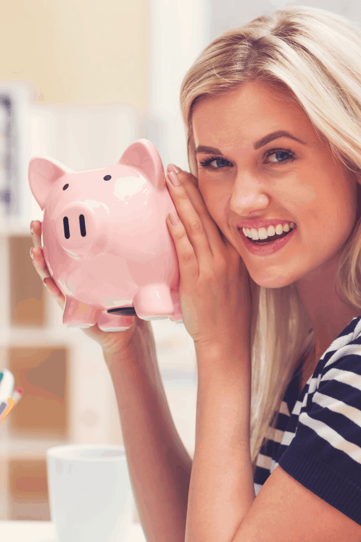 woman holding a piggy bank