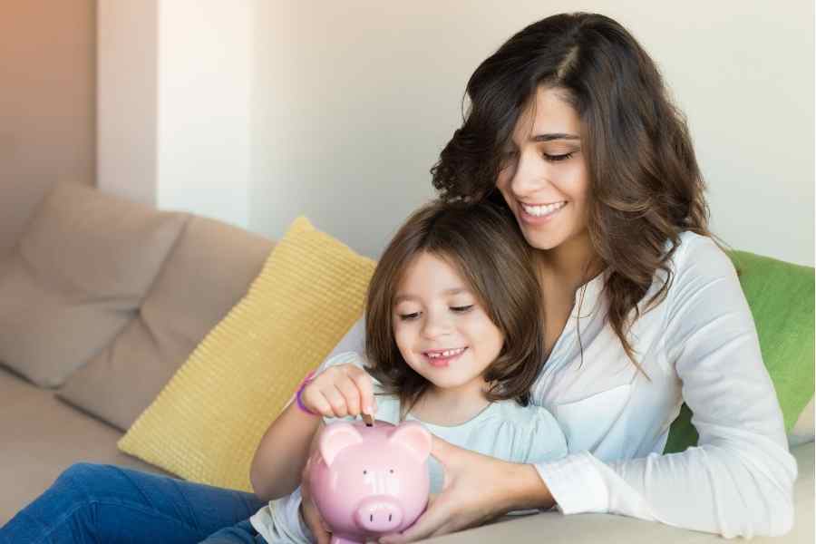 mom and child holding a piggy bank
