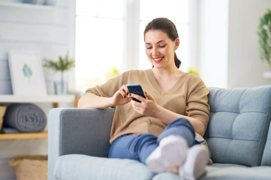 woman earning gift cards for surveys on a mobile phone