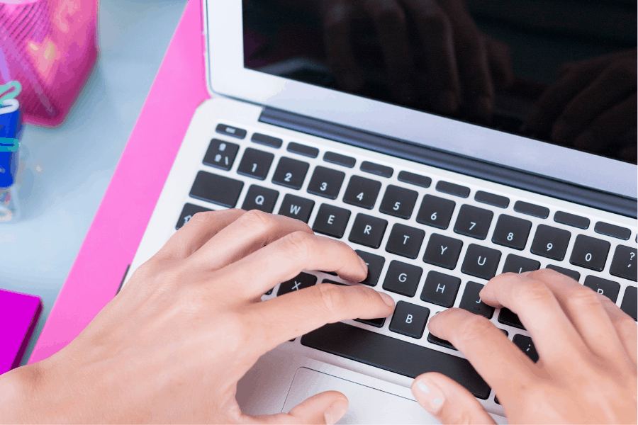 hands resting on a laptop keyboard