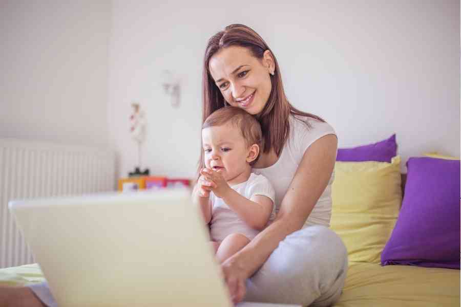 woman and daughter looking at a laptop