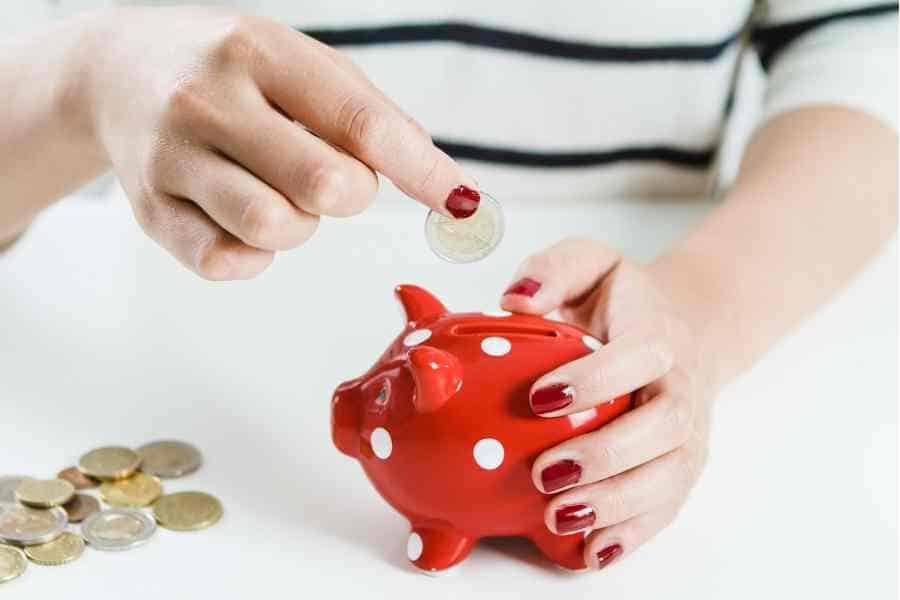 woman saving money in a piggy bank