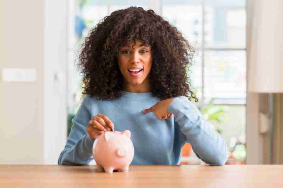 woman pointing to a piggy bank