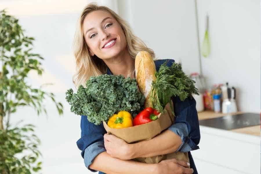 woman holding cheap groceries