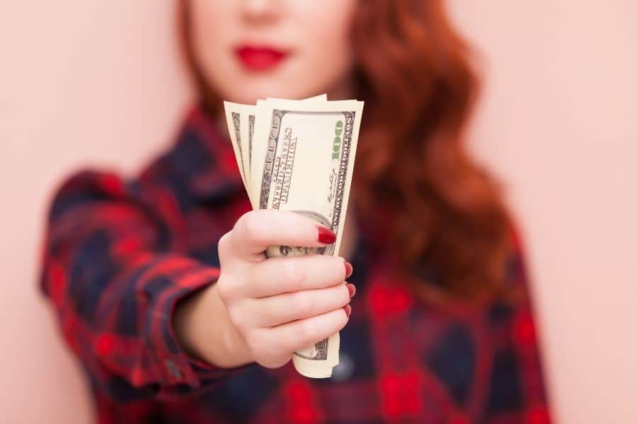 woman holding a handful of cash