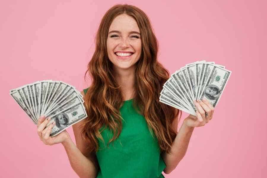 girl in green dress holding cash