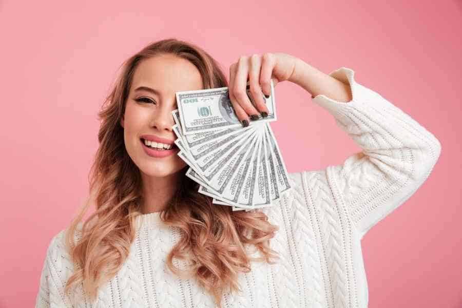 young woman holding cash