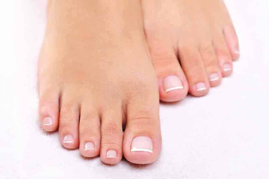 manicured feet against a white background