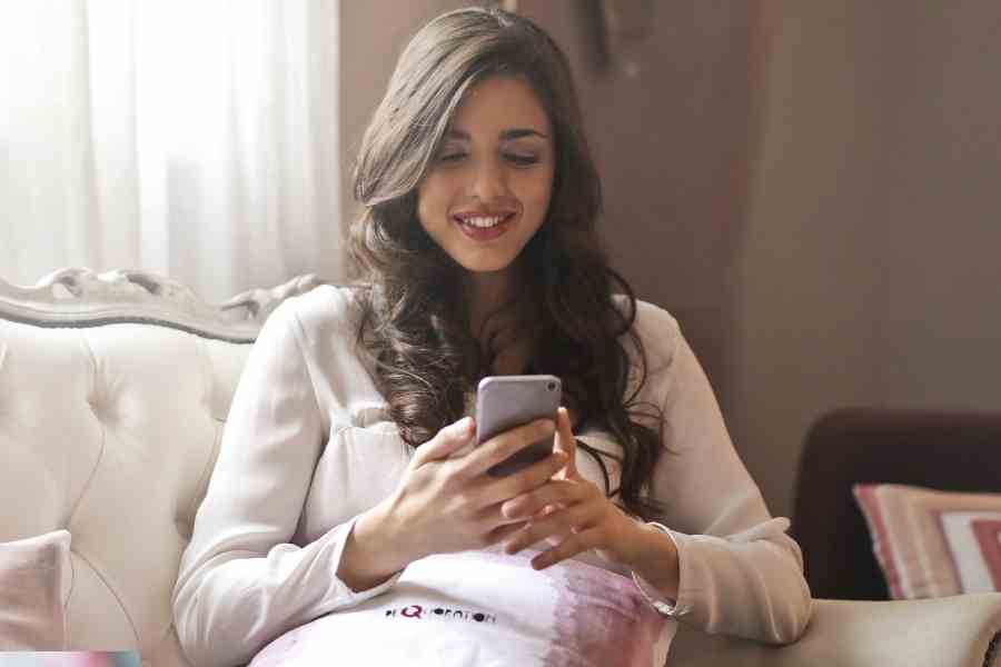 woman using her phone to send cash