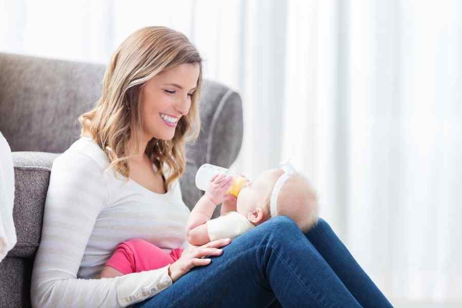 woman cradling her newborn on her lap