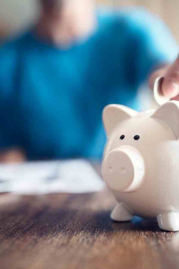 woman saving money in a piggy bank