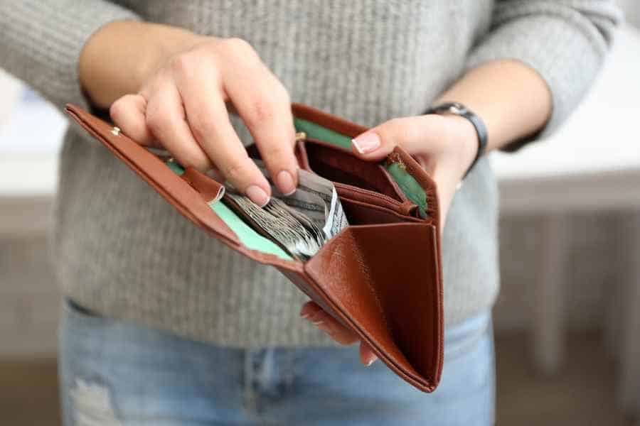 woman putting money in a wallet