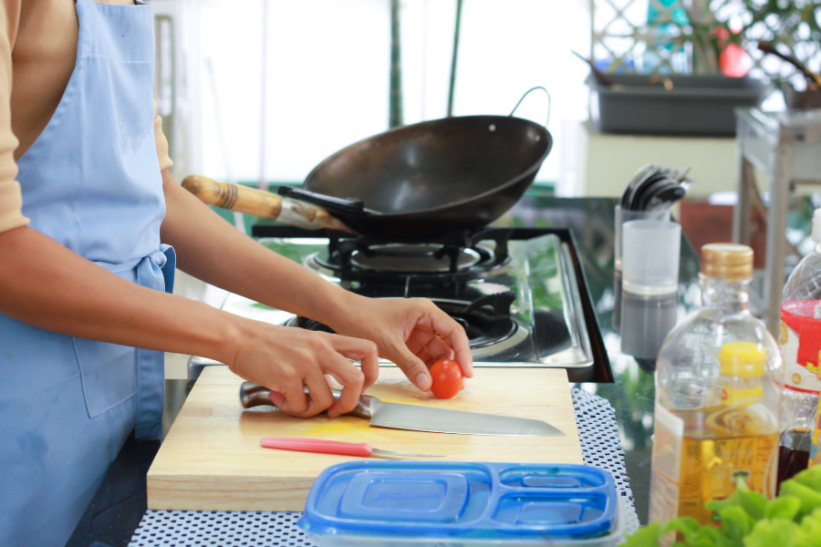 woman cooking with frugal food hacks